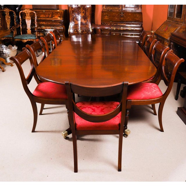 This is an elegant antique George III Regency Period mahogany dining table, dating from Circa 1780 and a set of ten...