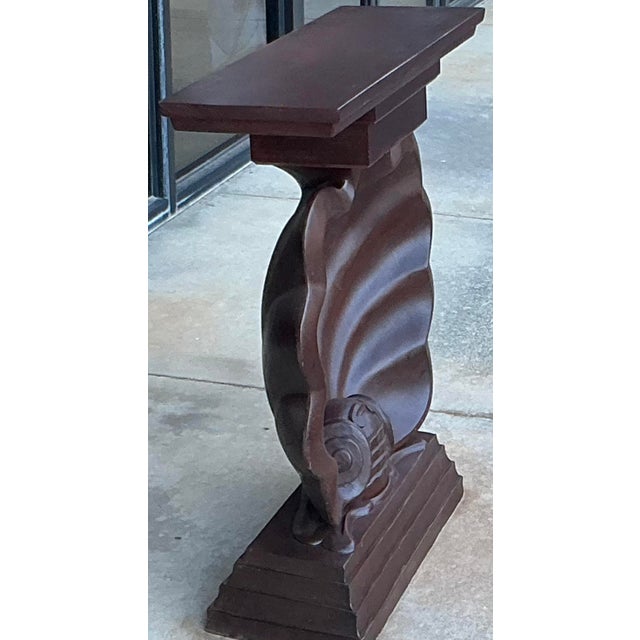 This is a Hollywood Regency style shell form console table that most likely dates to the 1970s or 80s. The top and base...