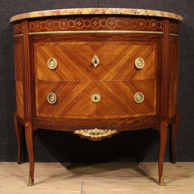 A half-moon dresser, early 20th-century France. A Louis XVI-style furniture finely inlaid with walnut, mahogany, maple,...