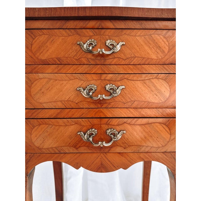This refined pair of French bedside tables was crafted in the Louis XV tradition during the mid-20th century. The design...