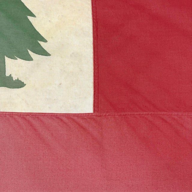 This vintage New England flag (or Continental flag) is made from a cotton cloth, with sewn panels and printed pine tree...