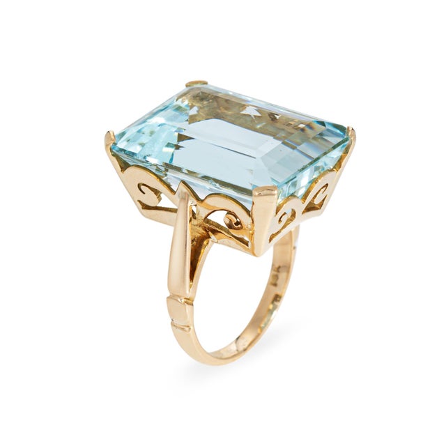 Stylish vintage aquamarine cocktail ring (circa 1940s to 1950s) crafted in 14k yellow gold. Emerald cut aquamarine...