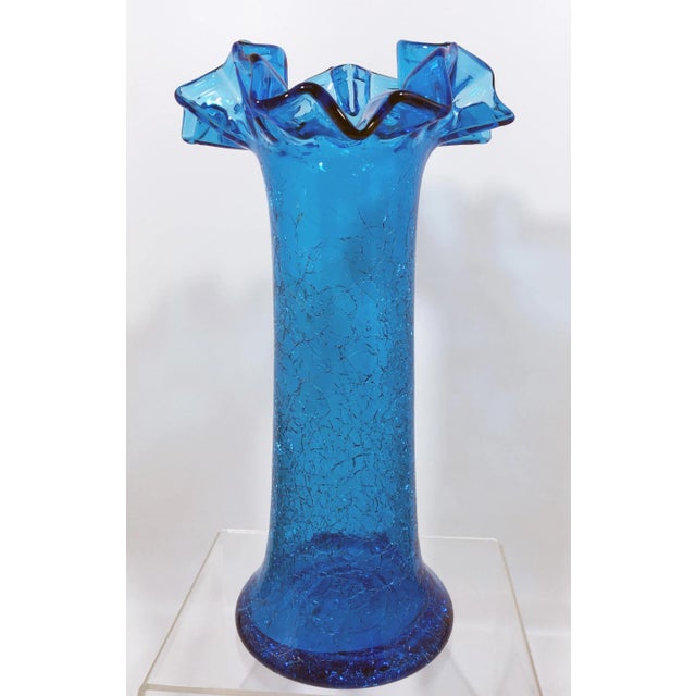 This Blenko-style crackle glass vase is in a stunning shade of blue! Dimensions: 6.75" x 4.97" x 12.125" Weight: 2.5 lbs.