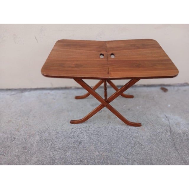 A rare and elegant serving table. Designed to save space in the dining room or living room, it can be opened to...