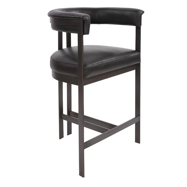 Take a seat! Our contemporary styled Carson Counter Stool features an iron frame finished in a dark brushed bronze. On the...