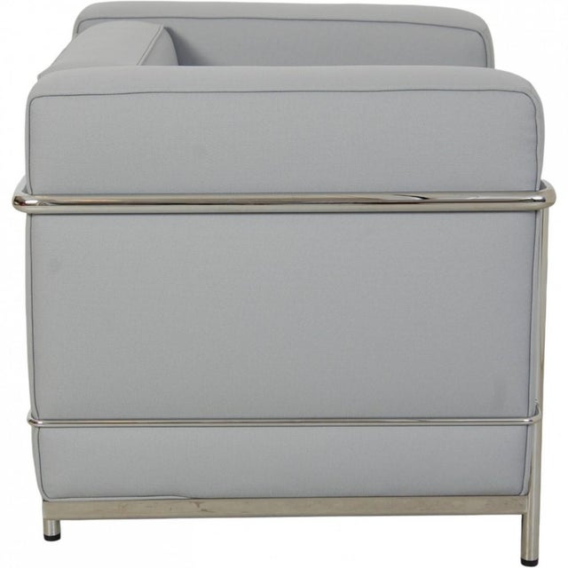 Le Corbusier LC2 chair upholstered in grey-blue fabric and with a chrome frame. The chair is from the 2010s and appears in...