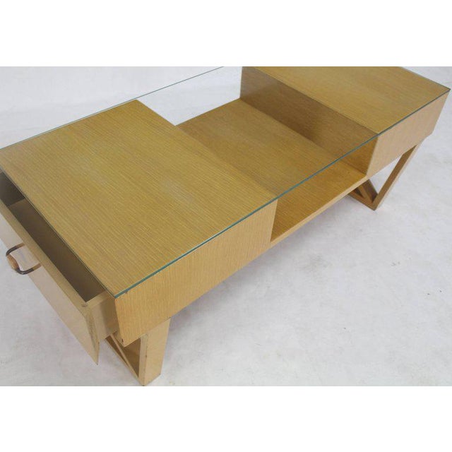 Mid-century modern circa 1950 glass top X-base coffee table with shelf and two-drawer storage compartments. Excellent...