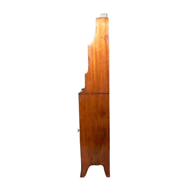 With a brass 3/4 gallery over shelves joining a pair of tambour doors and lower drawer. French style feet. Hilfiger...