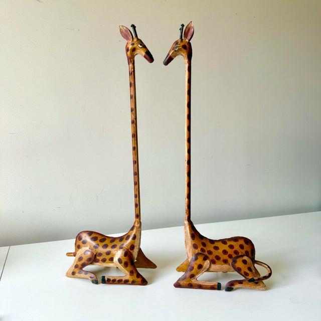 Vintage pair of hand painted tole long neck giraffes. Perfectly complementary these two make a unique statement.