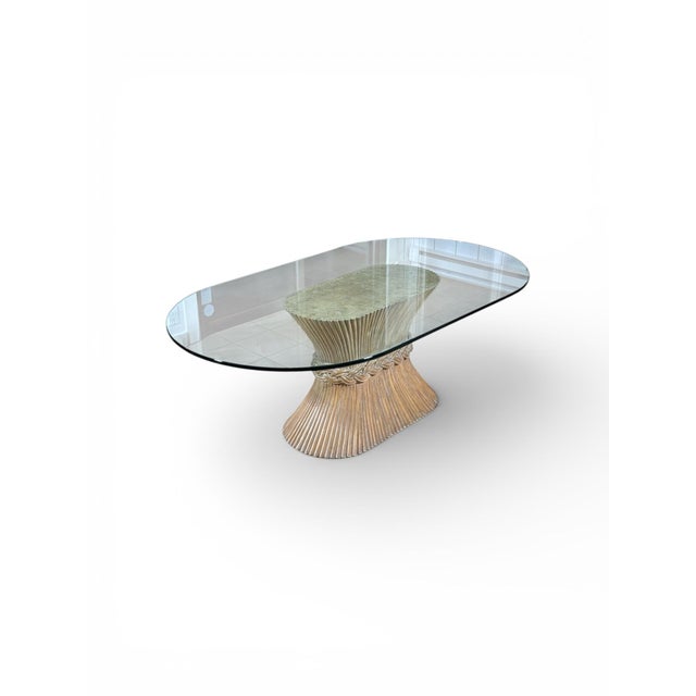 Classic McGuire design with signature wheat sheaf pedestal base, in bound rattan and an oval glass top measuring...