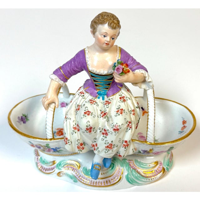 Meissen Rococo Figural Sweetmeat Dish with Seated Maiden and Twin Floral Baskets, Germany, Circa 1880 Meissen Rococo...