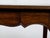 A French Louis XV style oak side table from circa 1900 with single drawer, scalloped apron, curving legs and scrolling...