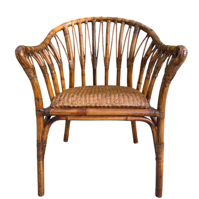 Beautiful vintage handcrafted rattan chair featuring a sculptural barrel back and tightly woven seat. The quality of...