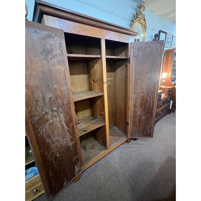 This clean armoire has nice clean lines and feature 2 doors that open to hanging space and case good folded storage space....