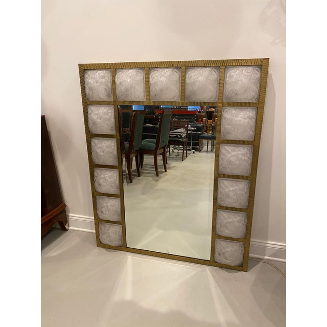 French Art Deco beveled mirror with fifteen glass signed panels by Degue. The panels having floral and geometric motif...