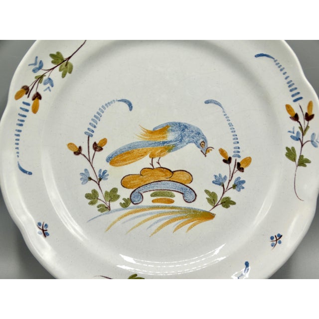 18th-Century hand painted French polychrome faience plate with bird from Nevers, France. It features a scalloped edge hand...