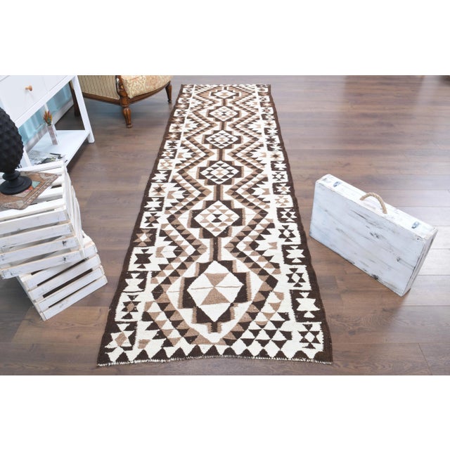 Vintage Turkish Hand-Knotted vintage rug is a semi-Vintage runner rug.'70s Eastern region of Turkey's unique rug is...