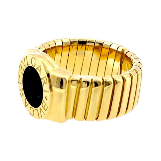 Bvlgari 18k Yellow Gold Onyx Tubogas ring with black onyx center. Measurements: Width: 13 mm Weight: 16.8 grams Size: 7.5...
