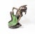 A charming bronze garden sculpture depicting a playful seated pixie or woodland fairy the animated figure wears a pointed...