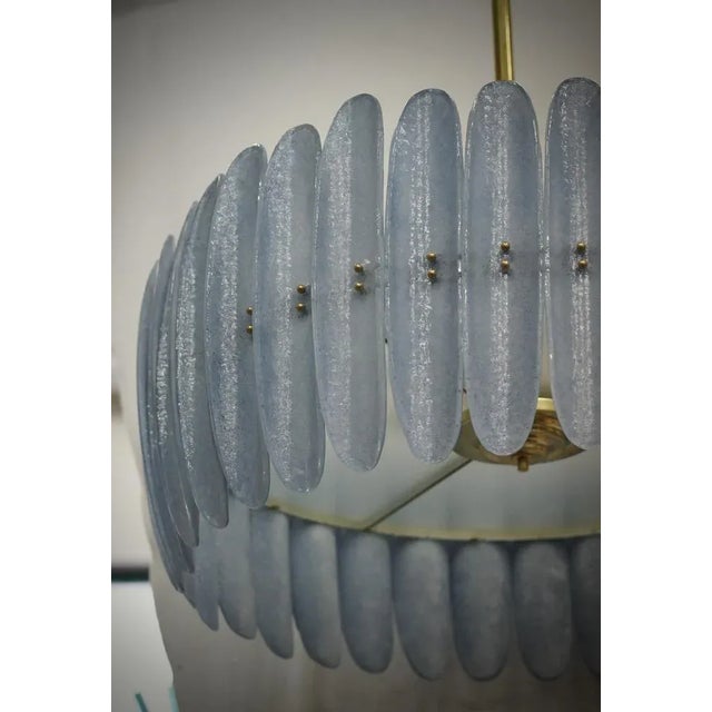 Fantastic round chandelier in Murano glass and polished brass. Note the shape of the blue Murano glass half shells, very...