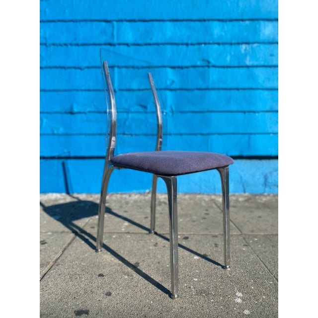 We have an accent chair that is a modern take on the Gazelle chair by Shelby Williams in purple with a lucite back that is...