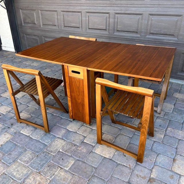 Maximize your dining space without sacrificing style with this stunning vintage mid-century modern teak drop-leaf dining...
