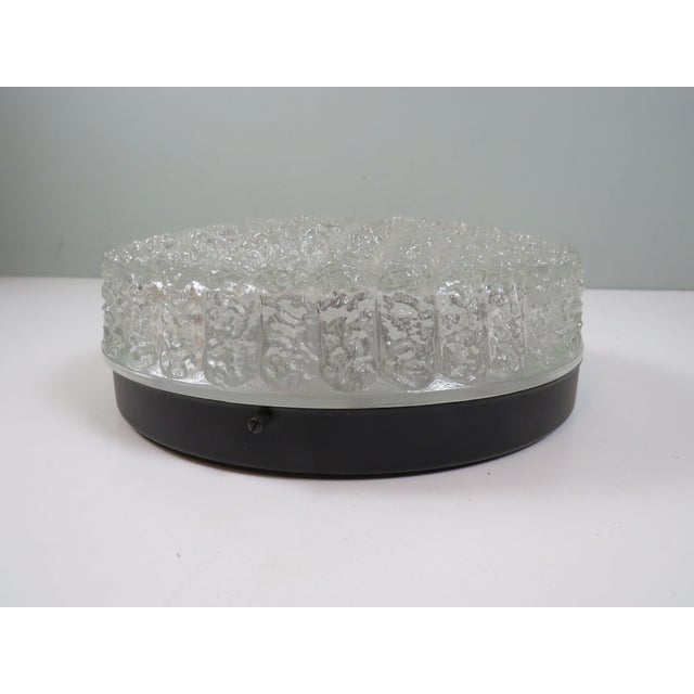 A beautiful vintage flush mount ceiling light manufactured by rzb, germany, during the 1970s. this elegant fixture...