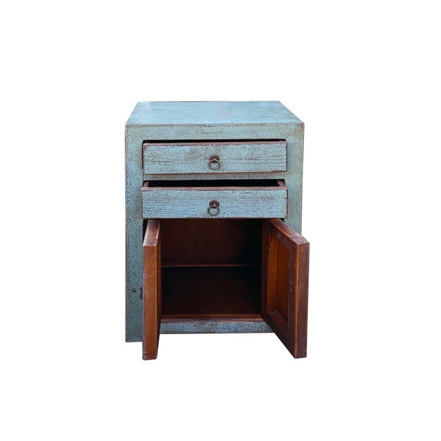This is a charming, vintage-style cabinet with a rustic, distressed finish. The cabinet features a subtle fade gray blue...