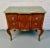 Elegant vintage French Louis XV–style commode featuring a serpentine bombe form, intricate marquetry veneer, and a rich...