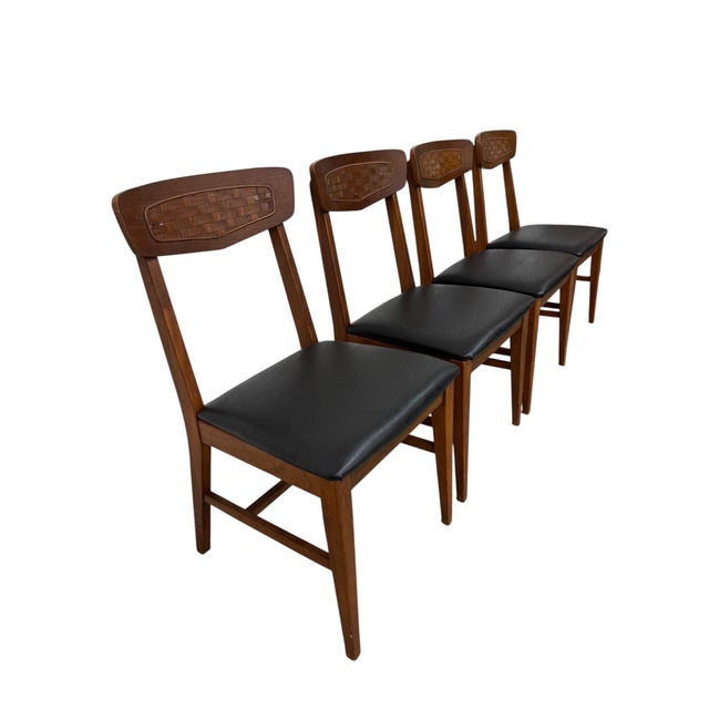Stylish and timeless, this set of four 1960’s Mid-Century Modern walnut dining chairs brings warm organic character to any...