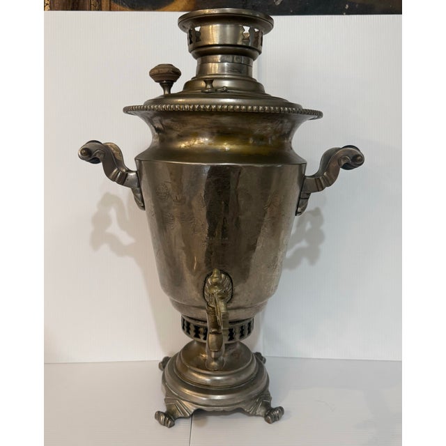 A substantial and highly decorative antique Russian samovar produced by the esteemed V.S. Batashev Steam Samovar Factory...