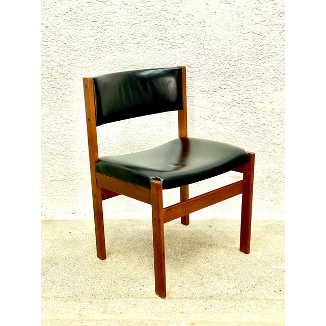 Classic made of solid teak and black leather This piece is attributed to the mentioned designer/maker. It has no...