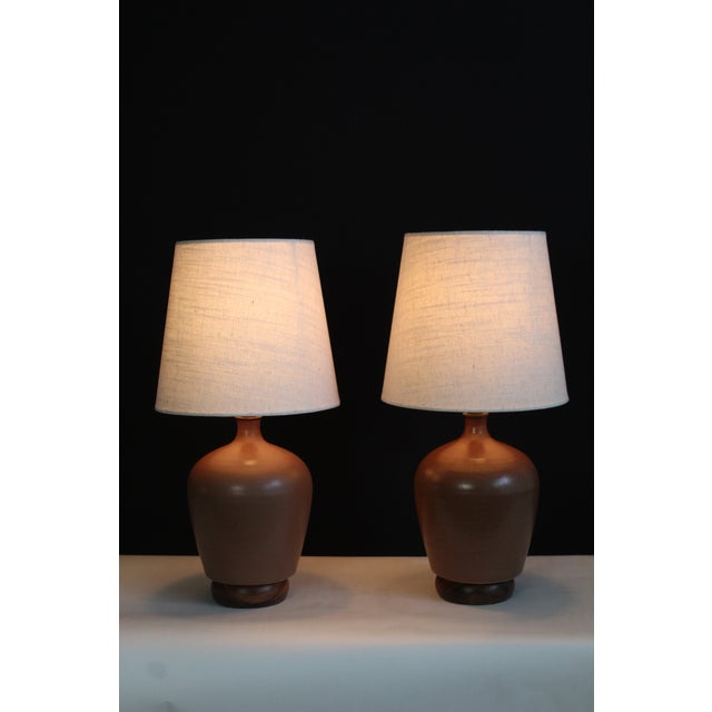 A pair of Pierre Digan influence lamps. Beautiful rich taupe glaze ceramic, . mounted on hand rubbed walnut bases. Hand...