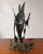 A spectacular Brutalist sculpture depicting an angelfish swimming in an underwater setting composed of metallic seaweed, a...