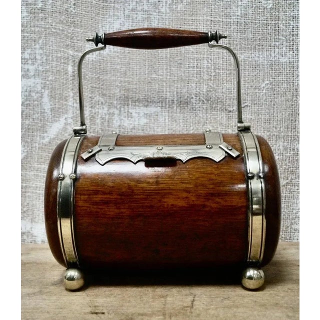 A Rare English Oak Biscuit Barrel. Made from Oak, and rare to find one that sits on its side. with metal banding and...