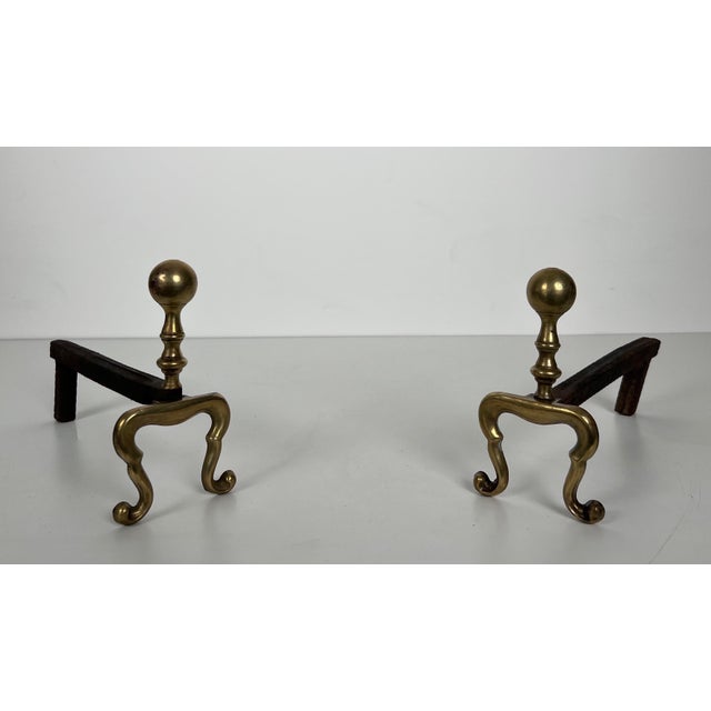 This pair of neoclassical style andirons is made of bronze and iron. It's a Frenchman. Circa 1920