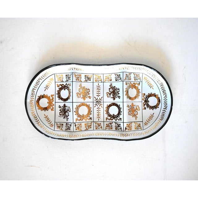 A vintage, mid-century black or smoke glass tray, dish, or catchall with three partitions and a white and gold...