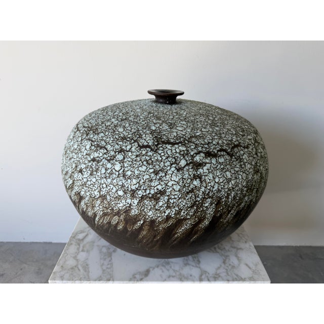 A beautifully crafted large vintage studio pottery bud vase featuring a striking organic form and richly textured glaze....