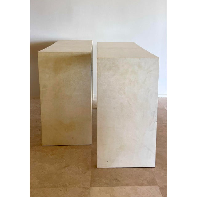Elevate any interior with this simple parchment-covered console table (2 available) inspired by the iconic designs of...