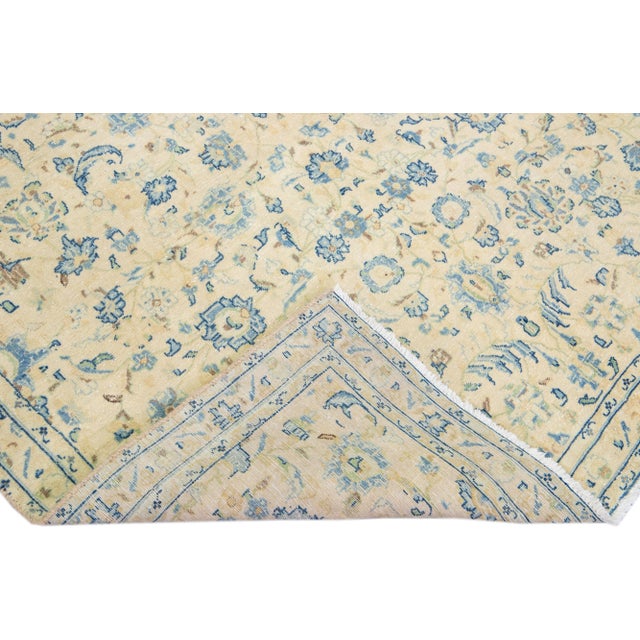 Beautiful vintage Persian distressed hand-knotted wool rug with an ivory color field. This piece has a blue and brown...