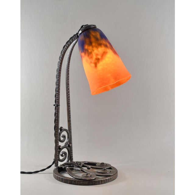 Daum frères A wonderful French 1925 art deco lamp in wrought iron. The forged base of excellent quality holds a rare model...