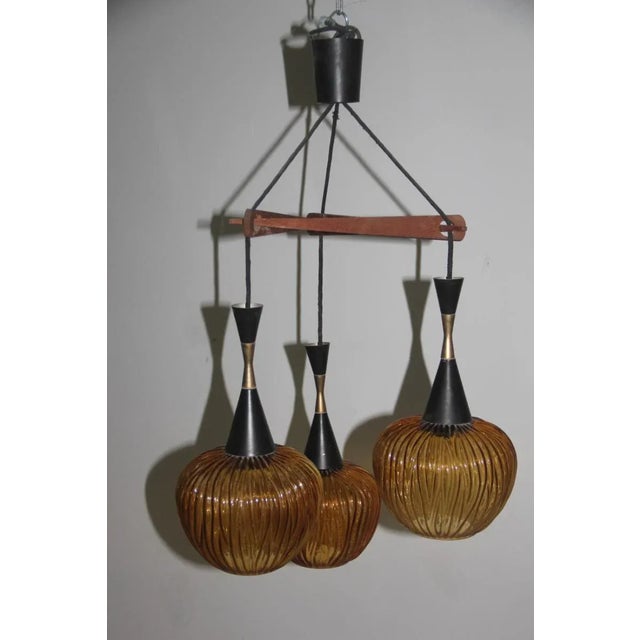 The design for this Italian pendant in glass, wood and galvanized metal was attributed to Tapio Wirkkala. Up to 250V...