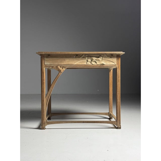 Art Nouveau style side table. Beautifully asymmetrical with a round arch and top on the left side. The arch continues into...