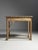 Art Nouveau style side table. Beautifully asymmetrical with a round arch and top on the left side. The arch continues into...