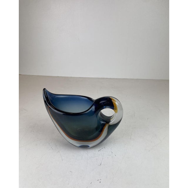 A striking decorative vase in thick, heavy murano glass, executed using the iconic sommerso technique. Developed in the...
