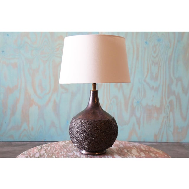 A 1960s ceramic lamp designed by Lee Rosen for Design Technics. A gourd form with Rosen’s signature textured finish, in an...