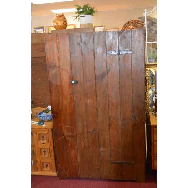 Great rustic wooden wardrobe/closet. Single door with metal/porcelain latch/knob & iron strap hinges. The inside is simply...