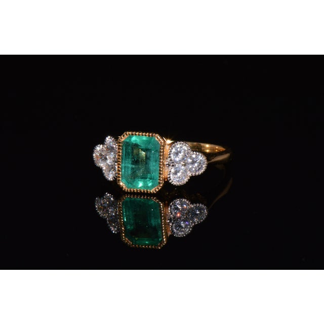 GIA certified 2.20CTS diamond and emerald solid 18K gold ring. This elegant ring features a GIA certified 1.66CT natural...