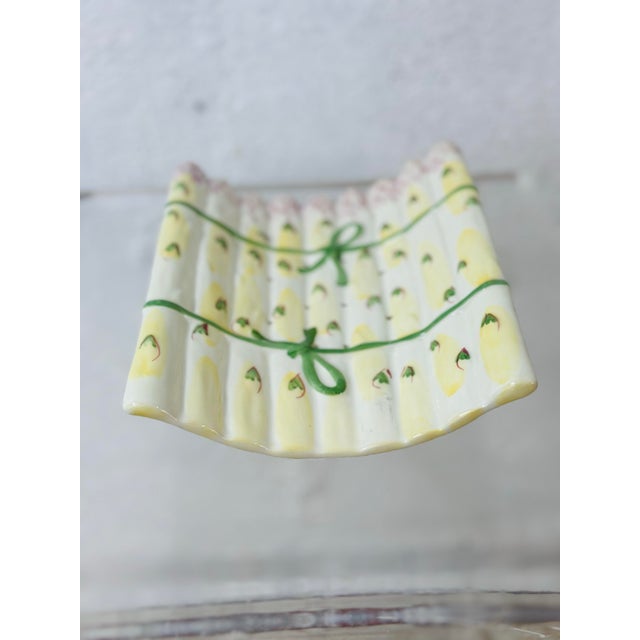This is a whimsical ceramic asparagus server or drip tray, designed in the form of bundled asparagus spears. The surface...