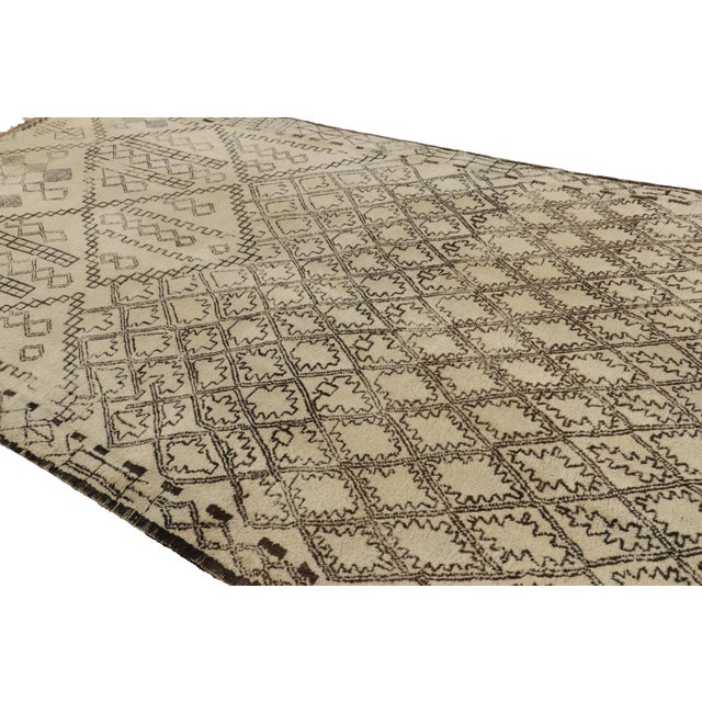 Hand-knotted in wool and originating from Morocco circa 1950-1960, this 7x13 vintage rug is among the most exciting new...